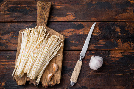 Top view macro shot of raw Enokitake mushrooms packaged in a black plastic tray. Healthy Asian food productの写真素材