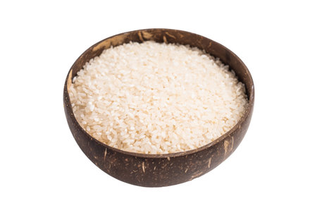 Uncooked white Rice in a bowl isolated on white background. top viewの写真素材