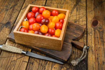 Rustic farm style mix of cherry tomatoes in a wooden crate clean minimal overhead composition suited for nutrition and recipe contentの写真素材