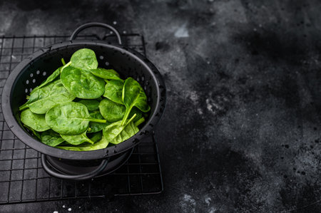 Nutrient rich fresh spinach leaves, perfect for adding flavor and health benefits to your meals and snacks. black background. top view.の写真素材