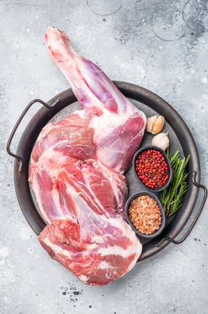 Whole fresh lamb mutton shoulder, inviting you to prepare a delicious roast that will impress your guests. white background. top view.の写真素材