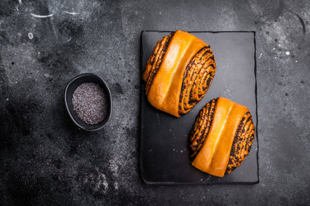 Sweet buns with poppy seed. black background. top view.の写真素材