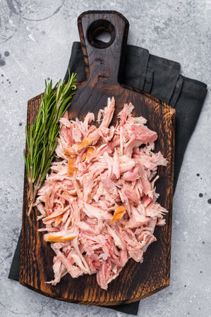 Shredded or Pulled Chicken meat on wooden board. grey background. top view.の写真素材
