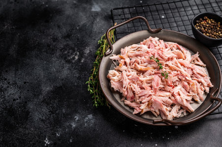Hot smoked Pulled Chicken meat, cooked poultry in a tray. black background. top view.の写真素材