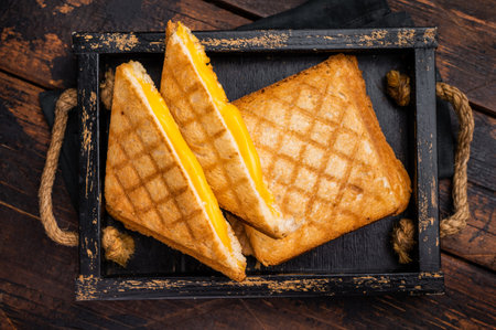 American hot Grilled cheese sandwich in wooden tray. wooden background. top view.の写真素材