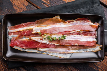 Smoked duck pastrami meat slices. wooden background. top view.の写真素材