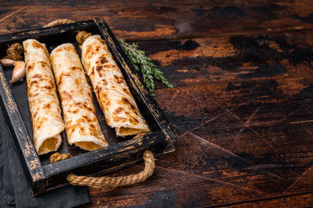 Aloo Paratha rolls, Indian Flatbread. wooden background. top view.