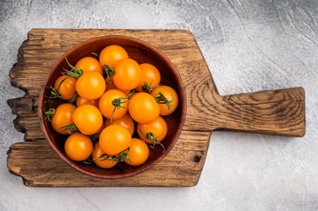 Fresh small yellow cherry tomatoes assortment, mini organic cocktail tomate mix. grey background. top view.の写真素材