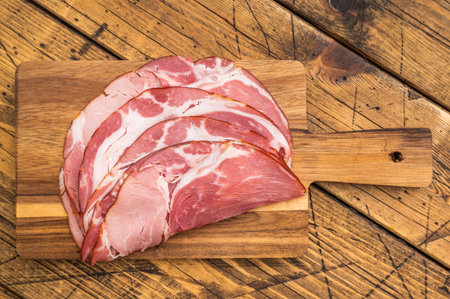 Traditional German schinken meat served with thyme and garlic on aged wood ideal for culinary photographyの写真素材