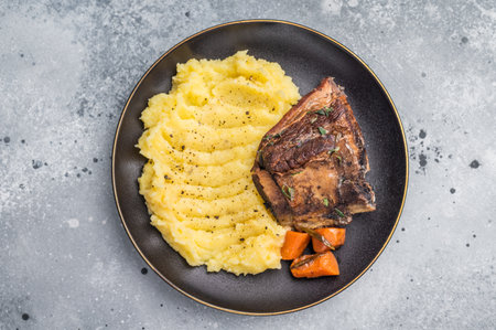 Slow cooked Beef short ribs, perfectly cooked and glazed with a rich barbecue sauce. grey background. top view.の写真素材