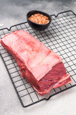Close-up of raw buffalo meat cuts, highlighting the marbling and vibrant hue, perfect for creating delicious and nutritious dishes. grey background. top view.の写真素材