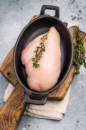 Raw white meat cuts, showcasing their natural shape and quality. A staple ingredient for countless delicious dishes in any kitchen. grey background. top view.の写真素材