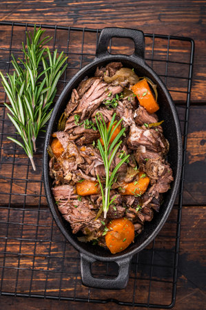 Skillet of beef bourguignon with tender beef, carrots, and mushrooms. wooden background. top view.の写真素材