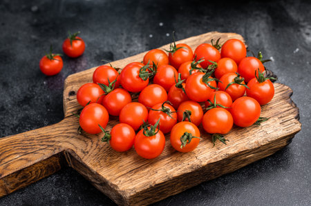 Sweet cocktail tomatoes, beautifully arranged, ready to elevate your culinary creations. A tasty treat for salads, appetizers, or snacks. top view.の写真素材