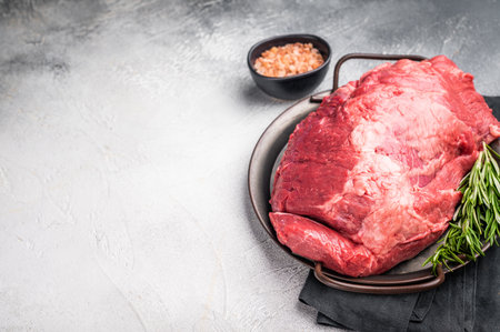 Beautifully arranged raw boneless beef shank pieces on a rustic platter, inviting creativity in the kitchen for delicious slow-cooked meals. grey background. top view.の写真素材