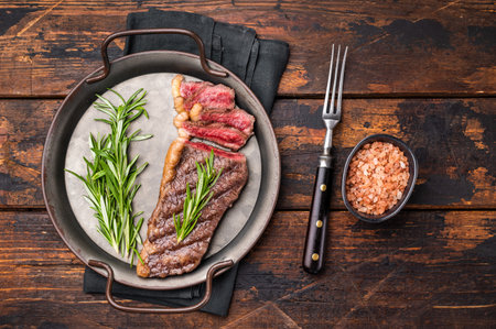 BBQ grilled Top Sirloin beef steak with herbs. wooden background. top view.の写真素材
