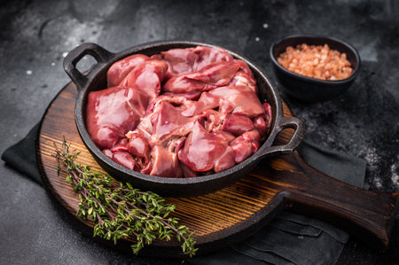 Vibrant raw chicken liver, perfect giblets for those seeking a protein-rich addition to their meals.black background. top view.の写真素材