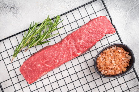 Premium beef steak, highlighting its tender texture and luxurious fat content. Ideal for those seeking a truly indulgent culinary experience. grey background. top view.の写真素材