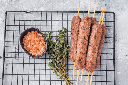 BBQ Roasted beef and lamb meat kebabs sausages, kofta kebab. grey background. top view.