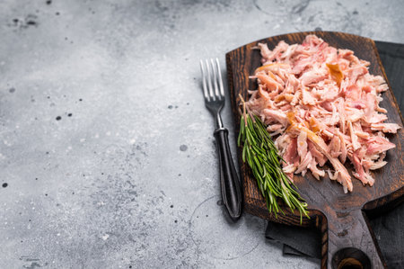 Shredded or Pulled Chicken meat on wooden board. grey background. top view.