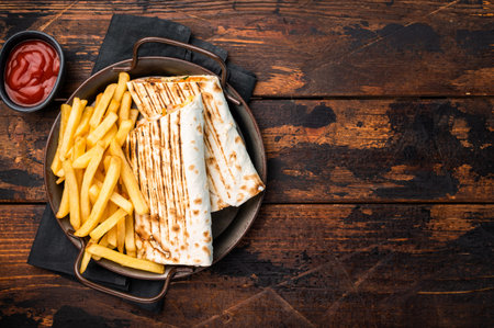Doner kebab, Shawarma with meat, salad and french fry. wooden background. top view.