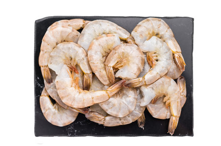 Uncooked Raw headless white shrimps prawns isolated on white backgroundの写真素材