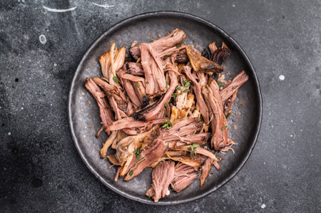 A tantalizing plate of pulled brisket, slow-cooked to perfection, drizzled with barbecue sauce for...