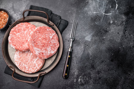 Frozen Meat cutlet, mincemeat of pork and beef for burgers. black background. top view.の写真素材