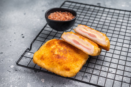 Fried Chicken cordon bleu cutlet with cheese and ham in breadcrumbs. grey background. top view.