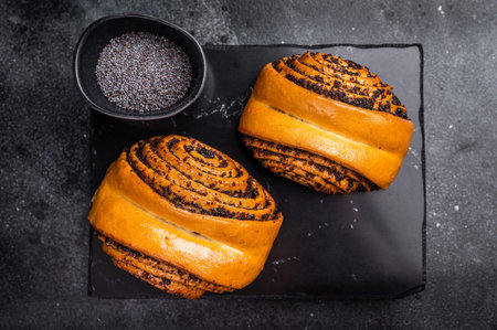 Sweet buns with poppy seed. black background. top view.の写真素材