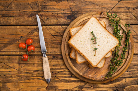 Ready for toasts Slices of wheat bread. wooden background. top view.