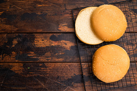Fresh Baked burger buns, bread for cooking hamburgers. wooden background. top view.
