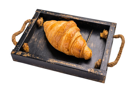 Baked single brown French croissant isolated on white background