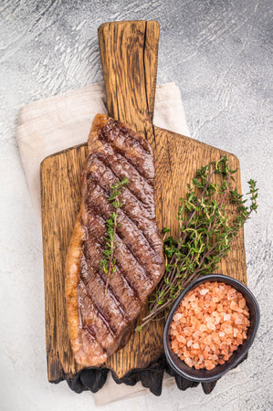 Grilled Top Sirloin, cooked rump beef steak. grey background. top view.の写真素材