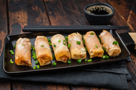 Fried spring rolls Lumpia crunchy appetizer with soy sauce and scallions minimal Asian food concept.