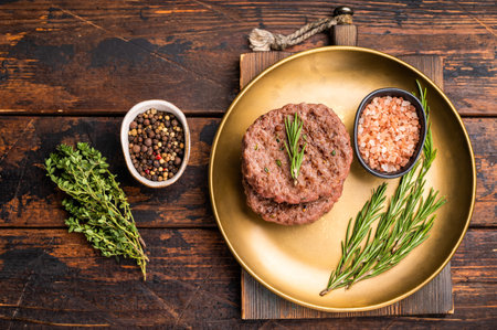 BBQ roasted hamburger chopped meat steaks patties with rosemary. wooden background. top view.