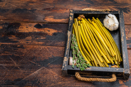 Fermented ramsons wild garlic in rustic kitchen composition seasonal foraged food ingredientの写真素材