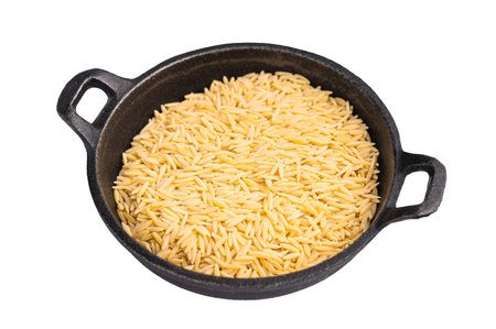 Raw Orzo pasta, uncooked dry Italian risoni in a bowl isolated on white background. top view.の写真素材