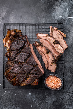 Roasted Roe Deer leg. slow cooked game meat of venison with bone. black background. top view.の写真素材