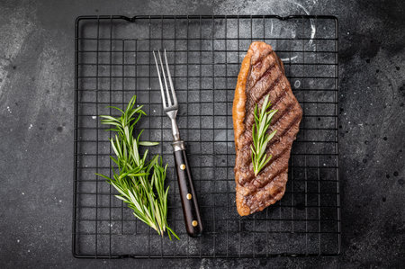 Grilled Brazilian picanha, rump cap beef steak. black background. top view.の写真素材