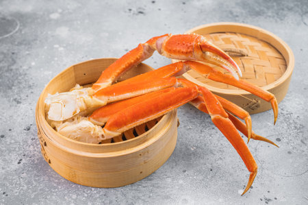 Luxury kamchatka red crab legs served in bamboo steamer on light textured background gourmet seafood...