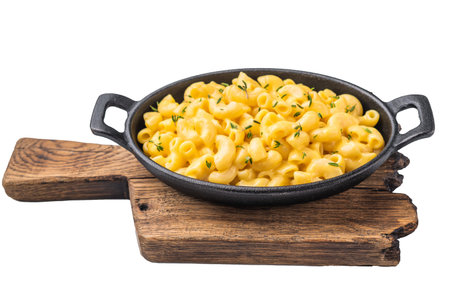 Savory mac and cheese presented in a cast iron dish, minimal white background highlights the rich textureの写真素材