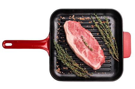 Fresh strip loin beef steak on a grill pan isolated on white background.の写真素材