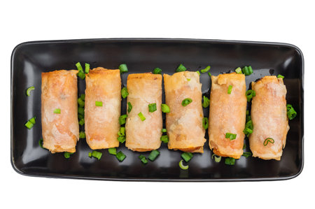 Fried spring rolls Lumpia finger food with scallions minimal Asian cuisine overhead shot.