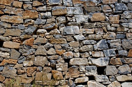 old wall from stones in the old greece island crete as a wallpaper backgroubnd