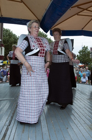 SPAKENBURG,HOLLAND - AUGUST 03:Unidentified woman shows original dutch dance in costume for tourist on the traditional days of Spakenburg August 03, 2011 in Spakenburg, Holland.のeditorial素材