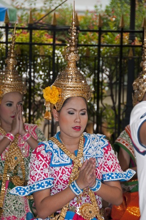 BANGKOK - APRIL 4: Unidentified girl in tradition costume dancing a riligious dance on April 04, 2011 in bangkok, Thailand, the girls dance and prey for you for moneyのeditorial素材