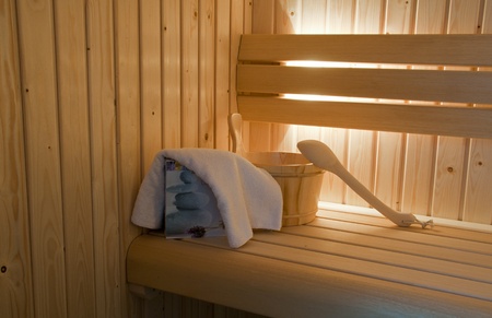 sauna interior with bucket and towels