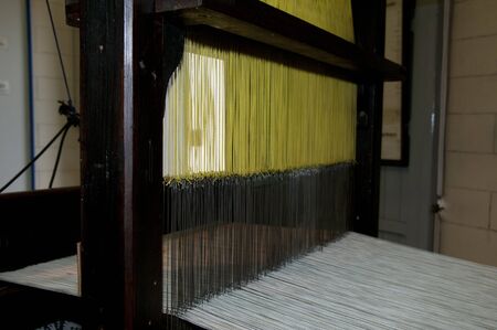 yellow and white cotton in a old loomのeditorial素材