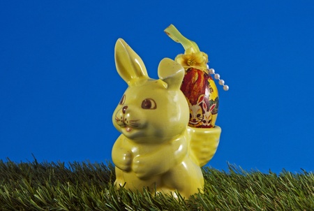easter bunny with eggs on green grassの写真素材